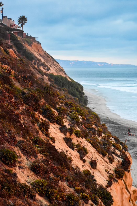Eroded coastal cliffs and a narrowing beach
