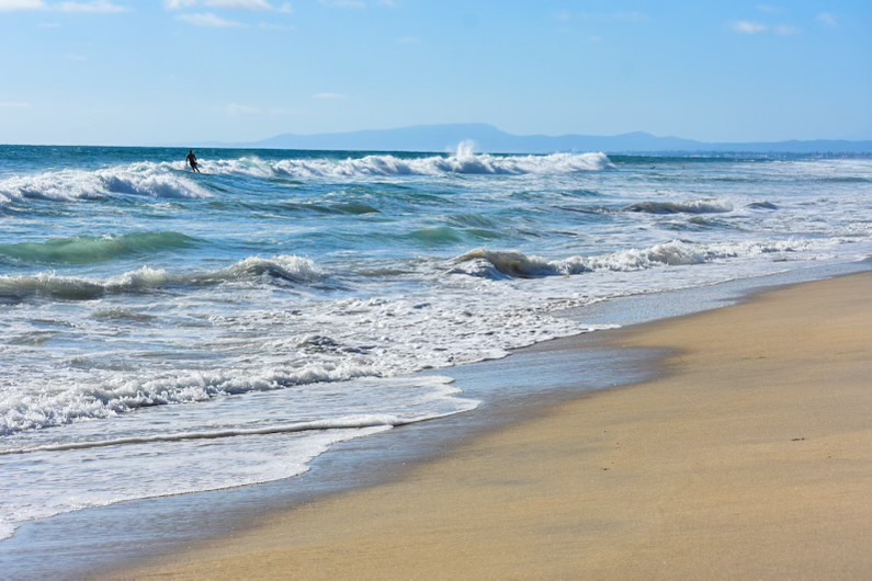 Aerial view of waves and sediment plumes near shore